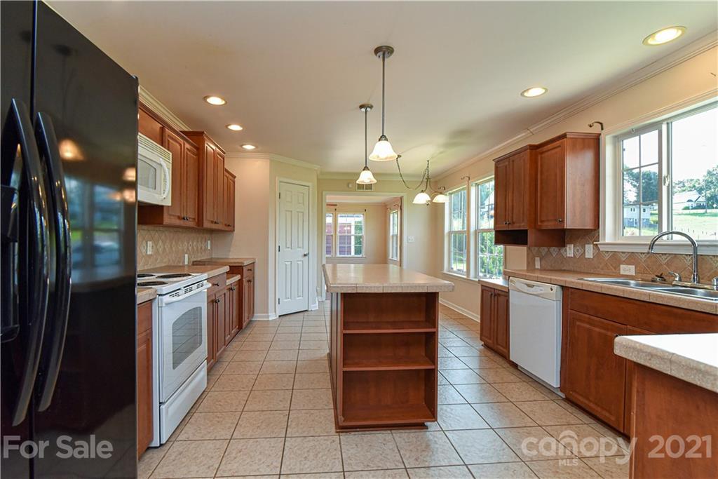 699 Pleasant Hill Road Clyde, NC 28721 - Photo 8 of 32 a large kitchen with stainless steel appliances granite countertop a stove a sink and a refrigerator