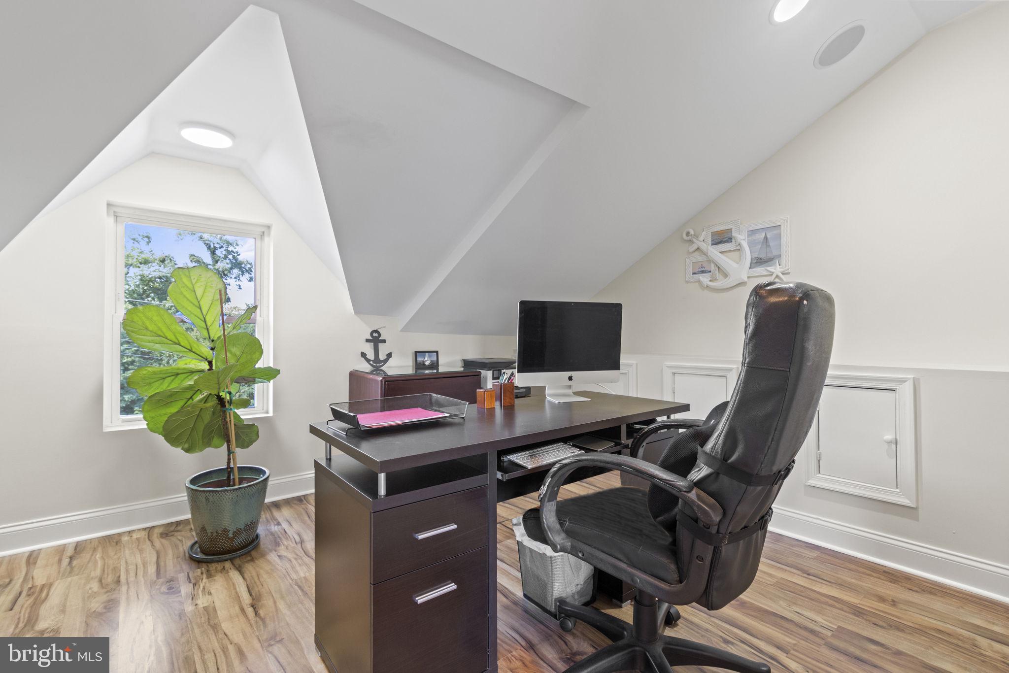 8646 Sandy Plains Road Dundalk, MD 21222 - Photo 15 of 38 a view of a workspace with furniture and a potted plant