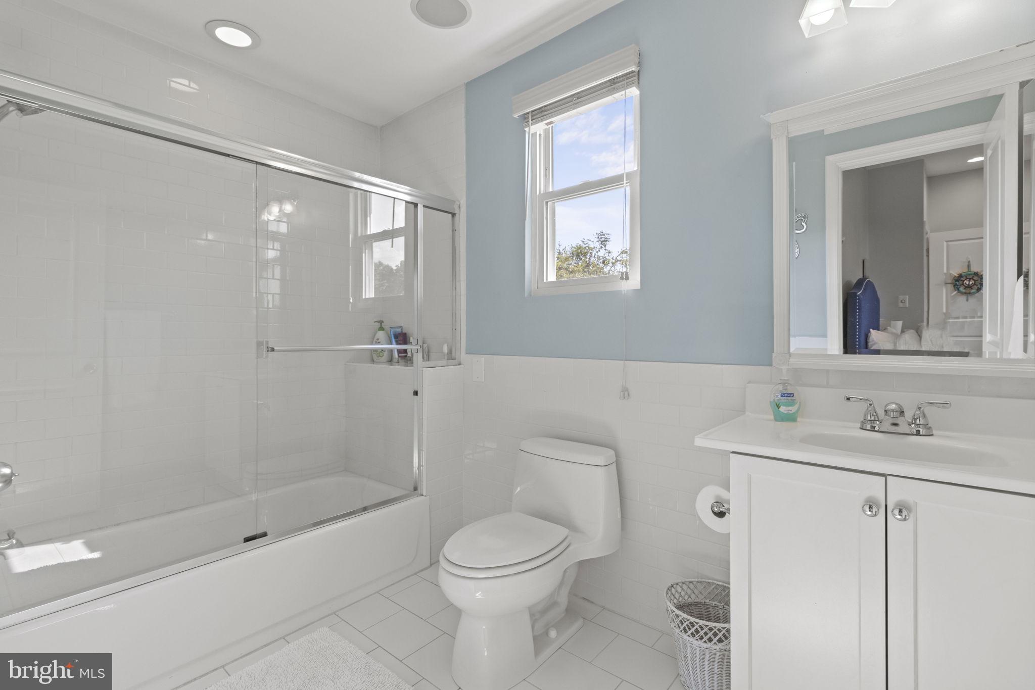 8646 Sandy Plains Road Dundalk, MD 21222 - Photo 20 of 38 a bathroom with a bathtub shower sink mirror and toilet