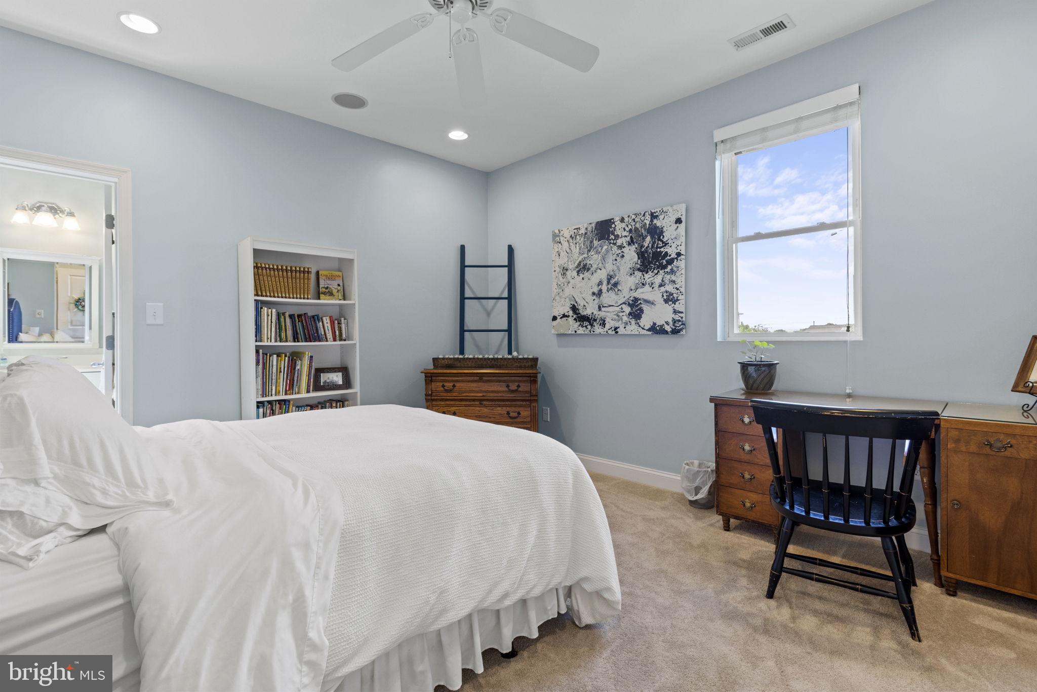 8646 Sandy Plains Road Dundalk, MD 21222 - Photo 22 of 38 a bedroom with a bed a table and a book shelf