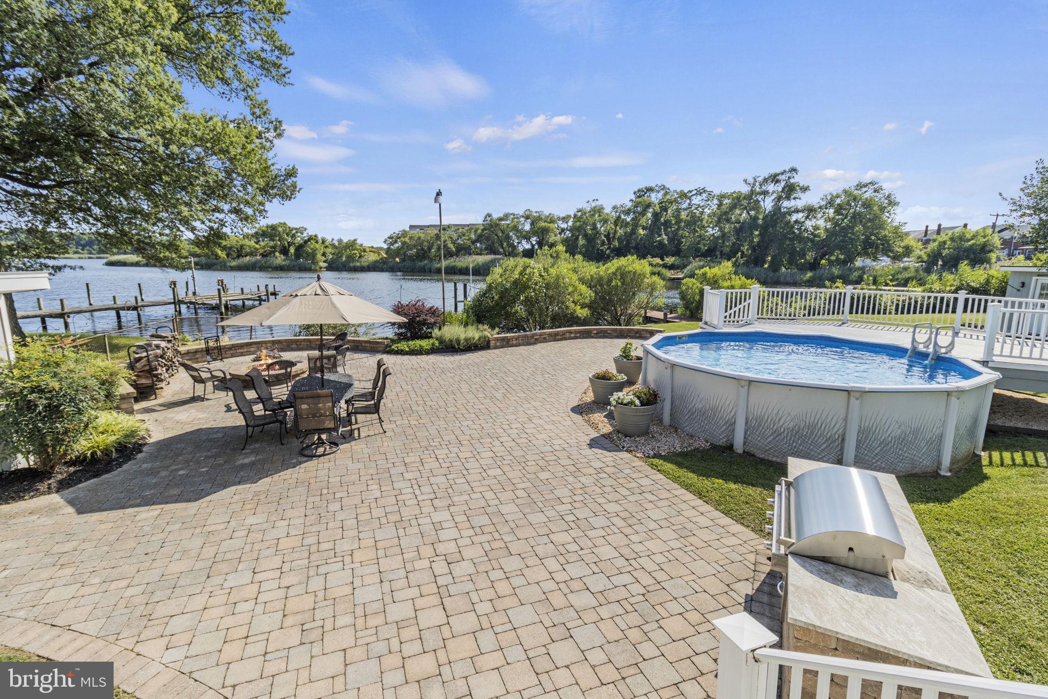8646 Sandy Plains Road Dundalk, MD 21222 - Photo 24 of 38 a view of a swimming pool with lawn chairs and a potted plant