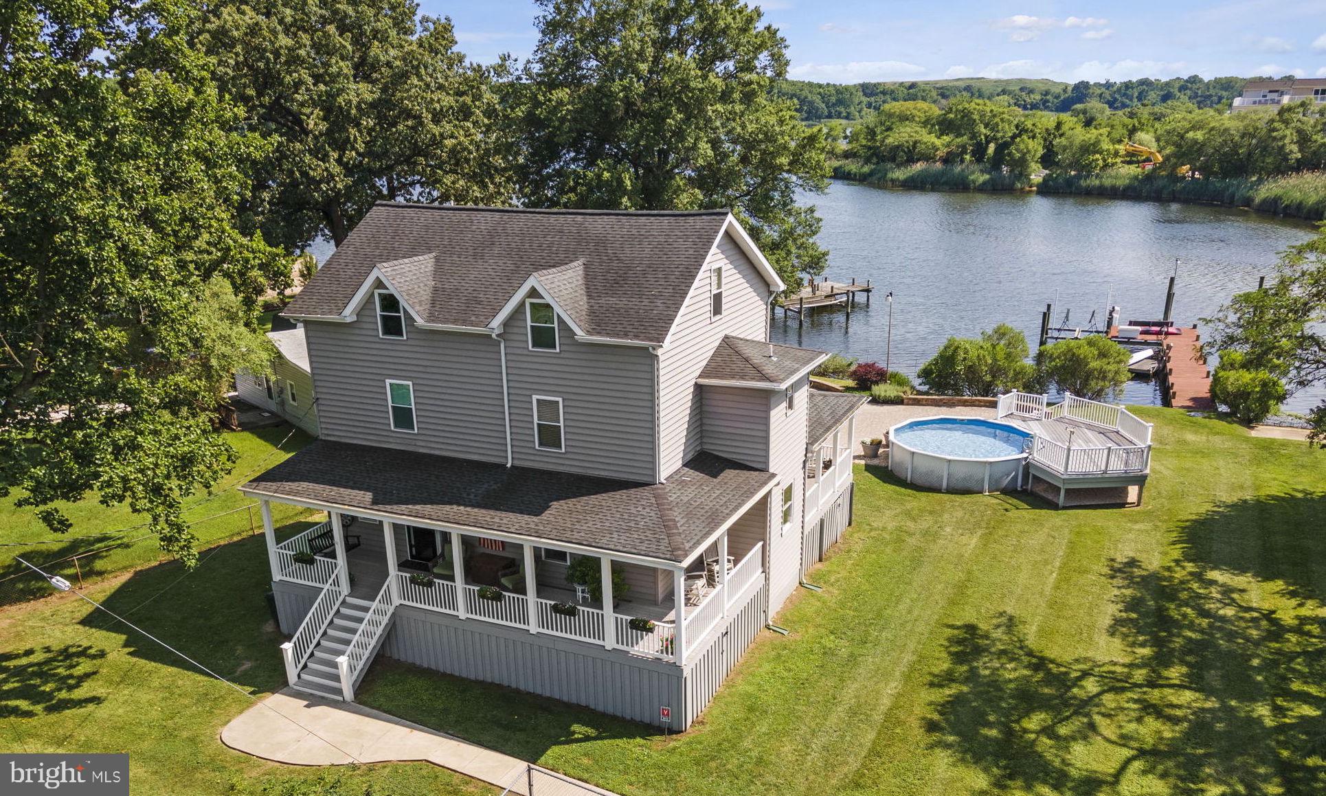 8646 Sandy Plains Road Dundalk, MD 21222 - Photo 30 of 38 an aerial view of a house with swimming pool and lake view
