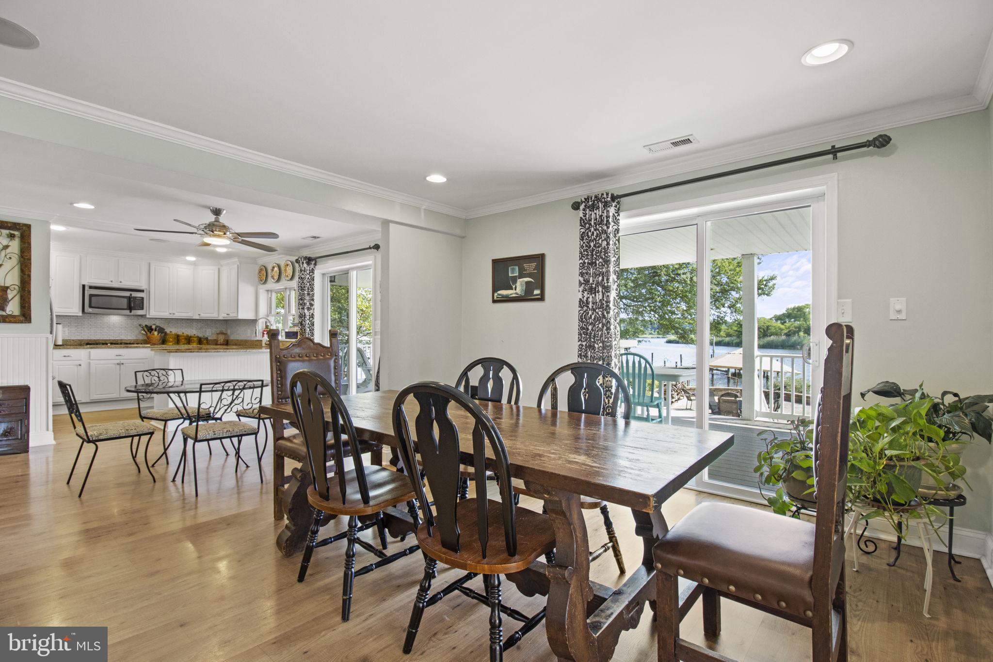 8646 Sandy Plains Road Dundalk, MD 21222 - Photo 5 of 38 a dining room with furniture and wooden floor to ceiling windows