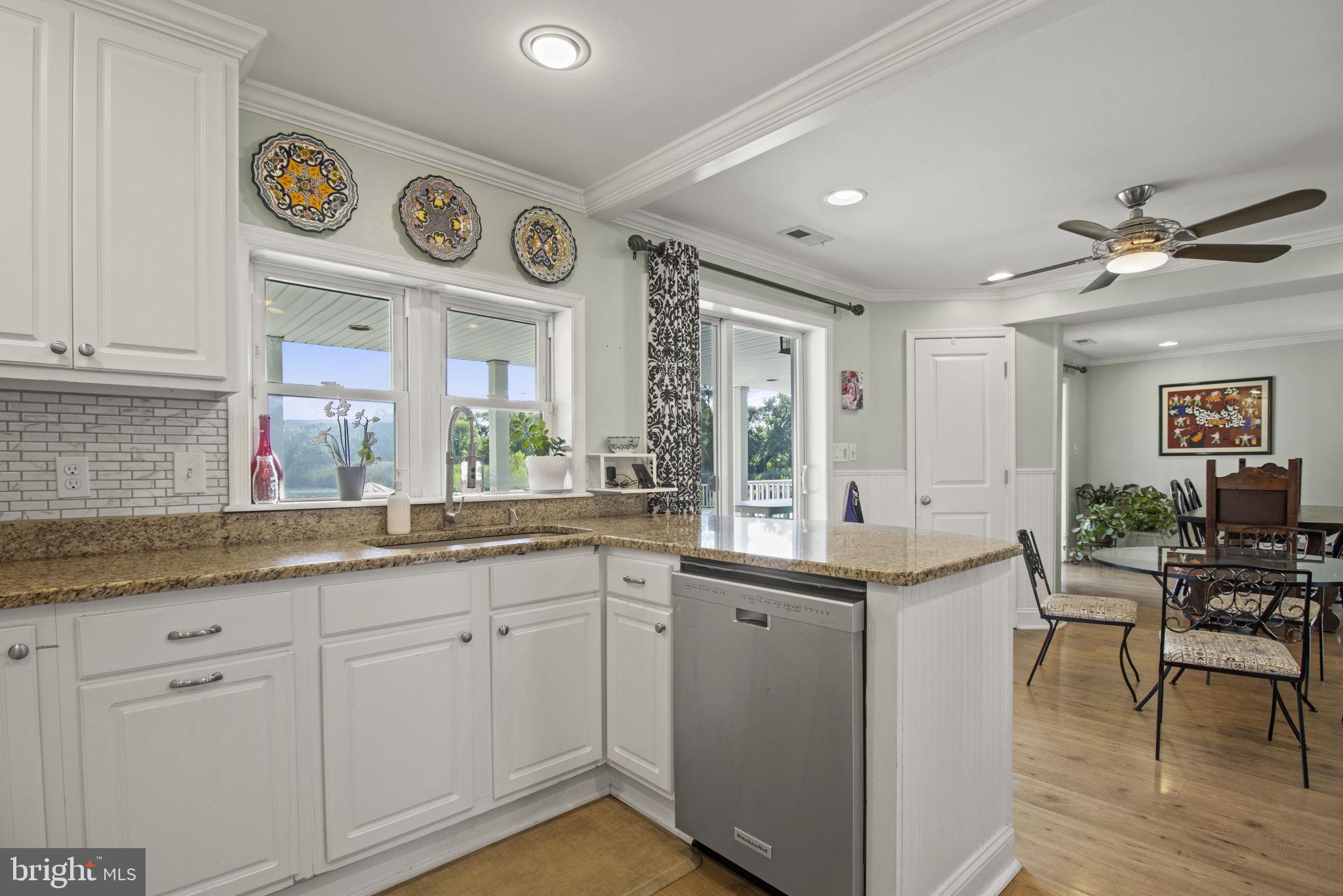 8646 Sandy Plains Road Dundalk, MD 21222 - Photo 8 of 38 a kitchen with cabinets and wooden floor