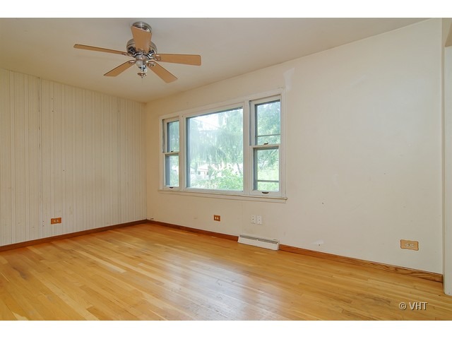 431 North Midlothian Road Mundelein, IL 60060 - Photo 2 of 10 a view of an empty room with wooden floor and a window
