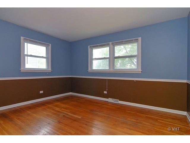 431 North Midlothian Road Mundelein, IL 60060 - Photo 5 of 10 an empty room with wooden floor and windows