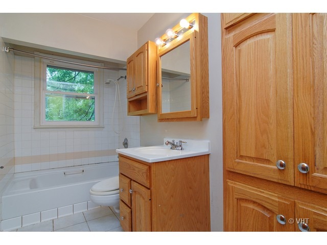 431 North Midlothian Road Mundelein, IL 60060 - Photo 9 of 10 a bathroom with a sink a toilet and a mirror