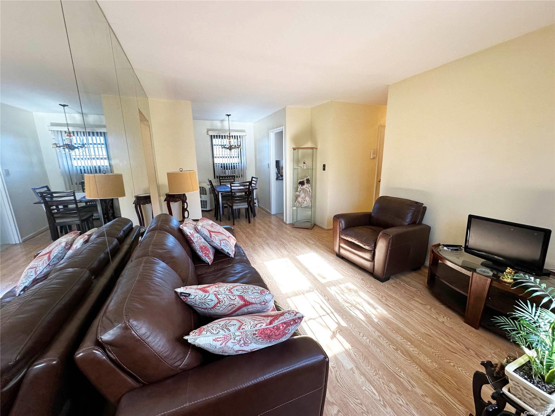 141-30 77th Road, Unit 3A Queens, NY 11367 - Photo 11 of 19 a living room with furniture and a flat screen tv