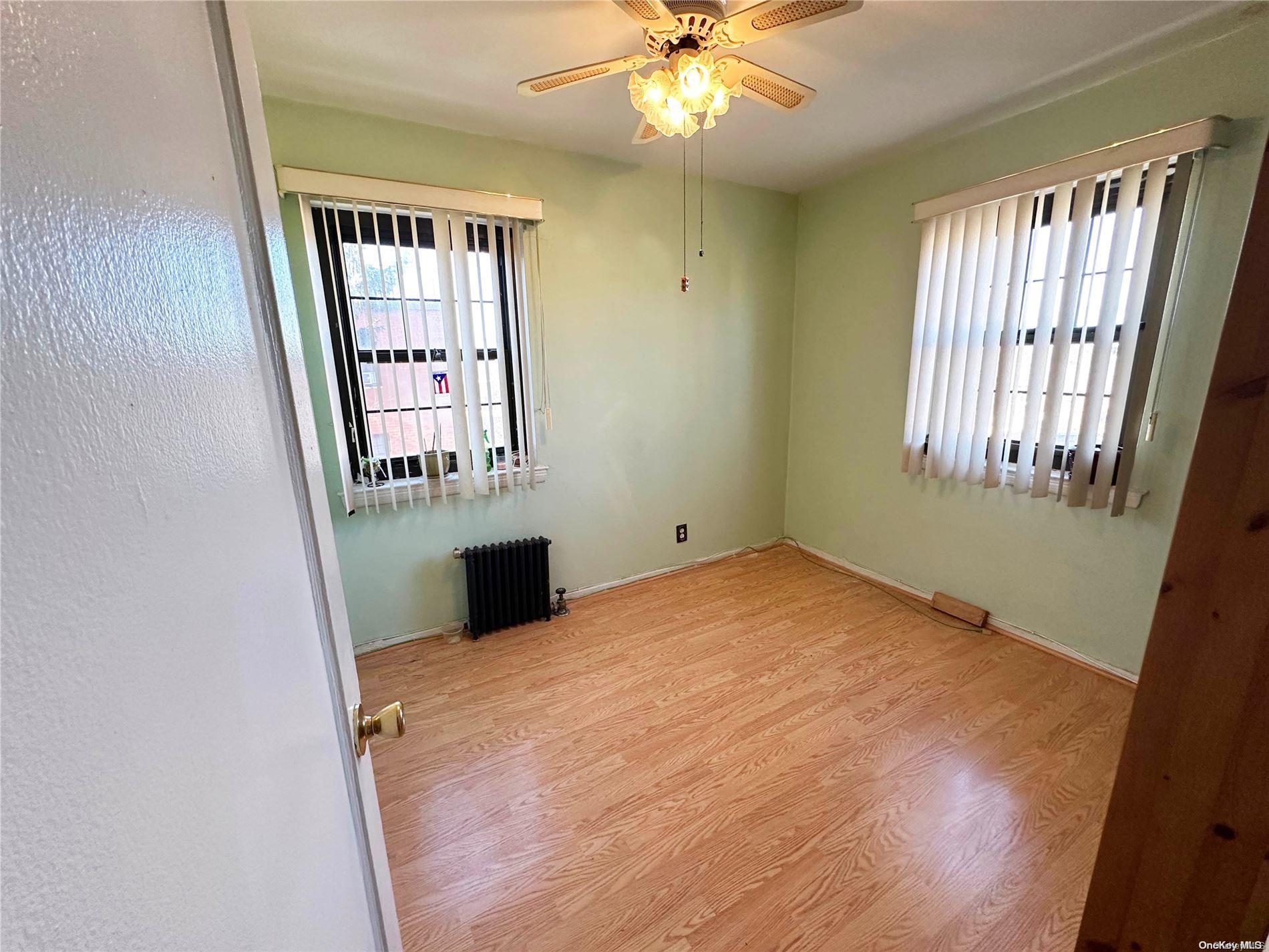141-30 77th Road, Unit 3A Queens, NY 11367 - Photo 14 of 19 an empty room with windows and entrance