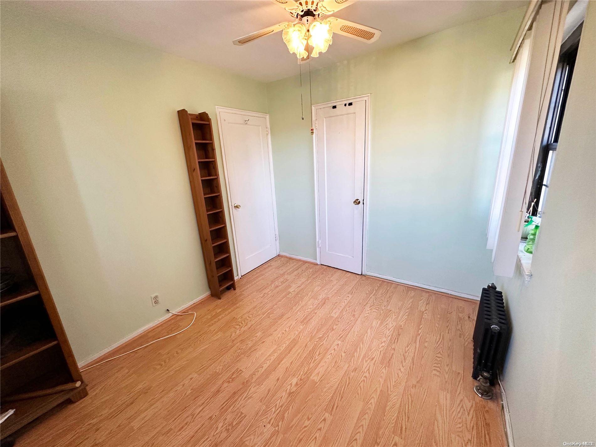 141-30 77th Road, Unit 3A Queens, NY 11367 - Photo 15 of 19 a view of a room with wooden floor and staircase