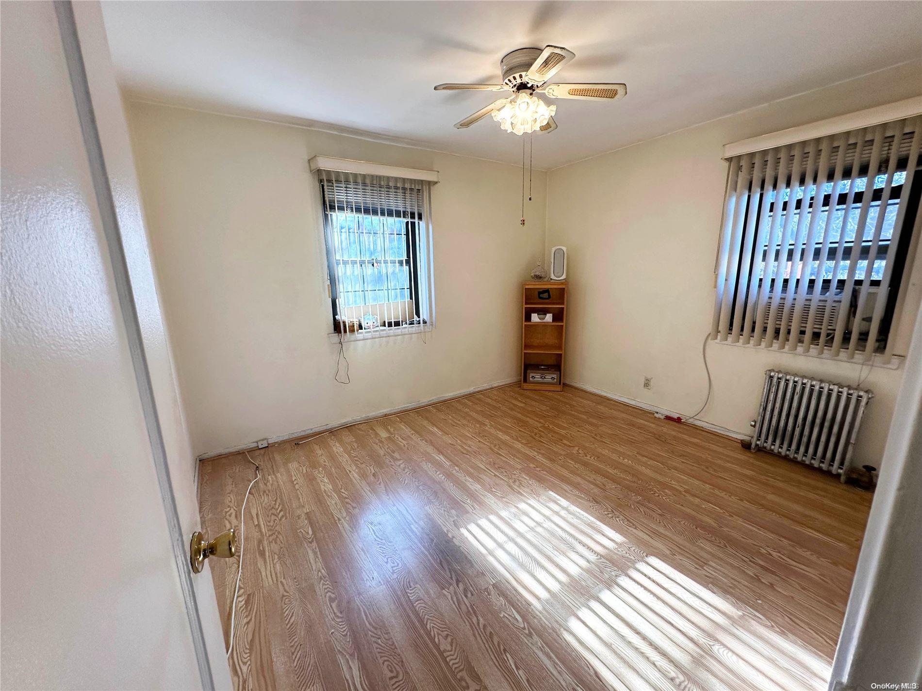 141-30 77th Road, Unit 3A Queens, NY 11367 - Photo 16 of 19 wooden floor in an empty room with a window