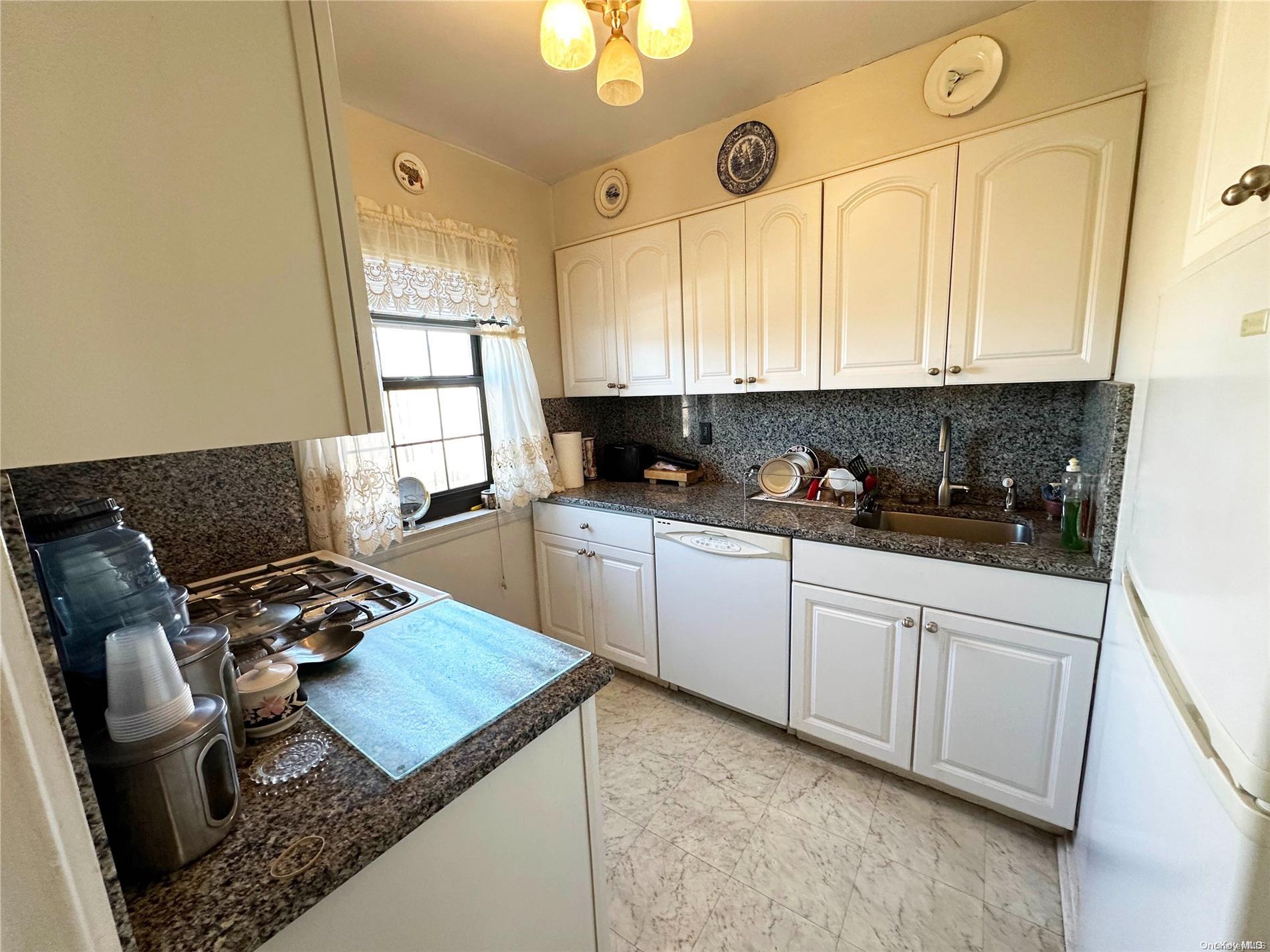 141-30 77th Road, Unit 3A Queens, NY 11367 - Photo 6 of 19 a kitchen with stainless steel appliances granite countertop a sink stove and cabinets