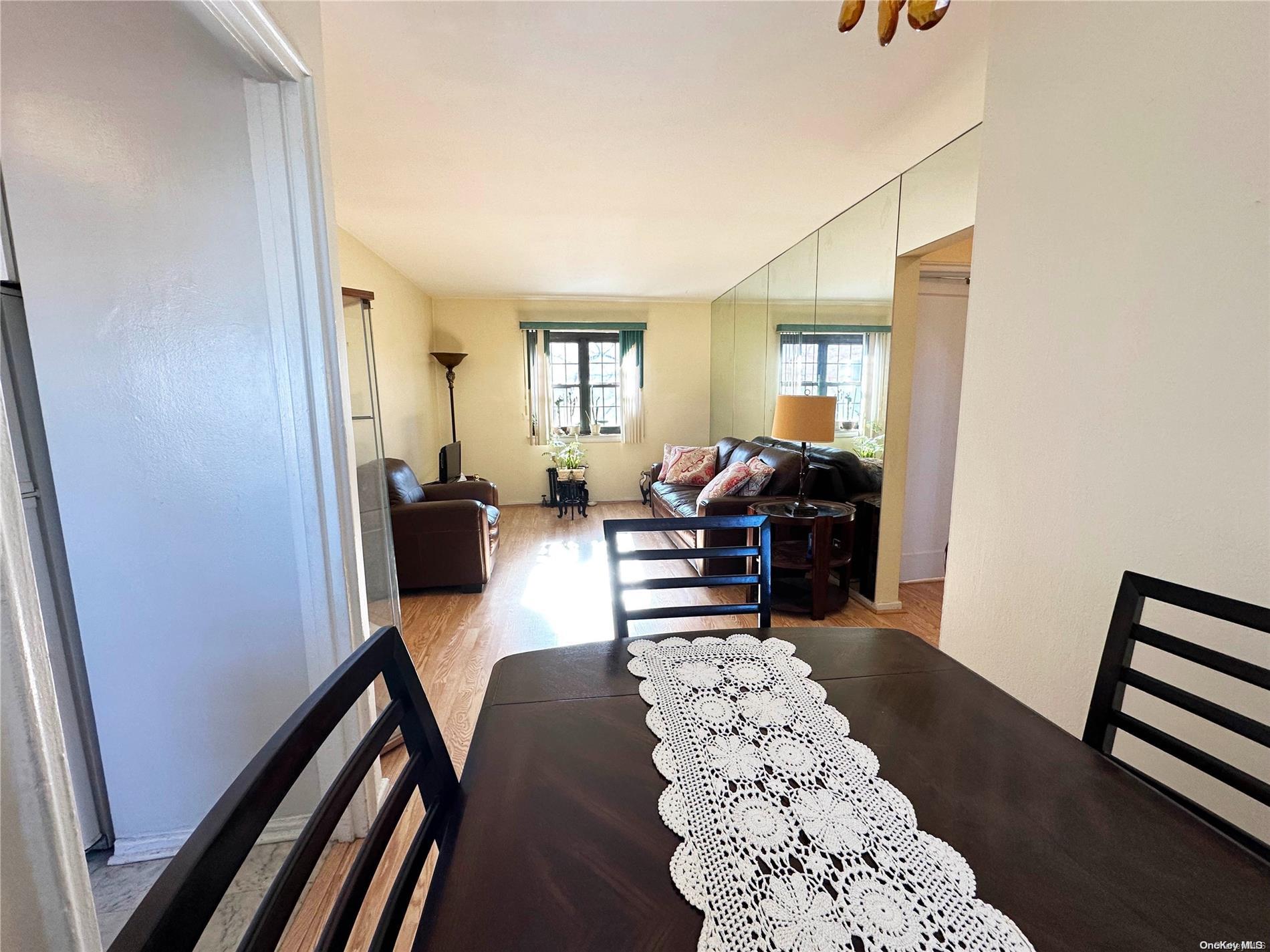 141-30 77th Road, Unit 3A Queens, NY 11367 - Photo 9 of 19 a living room with furniture rug and wooden floor