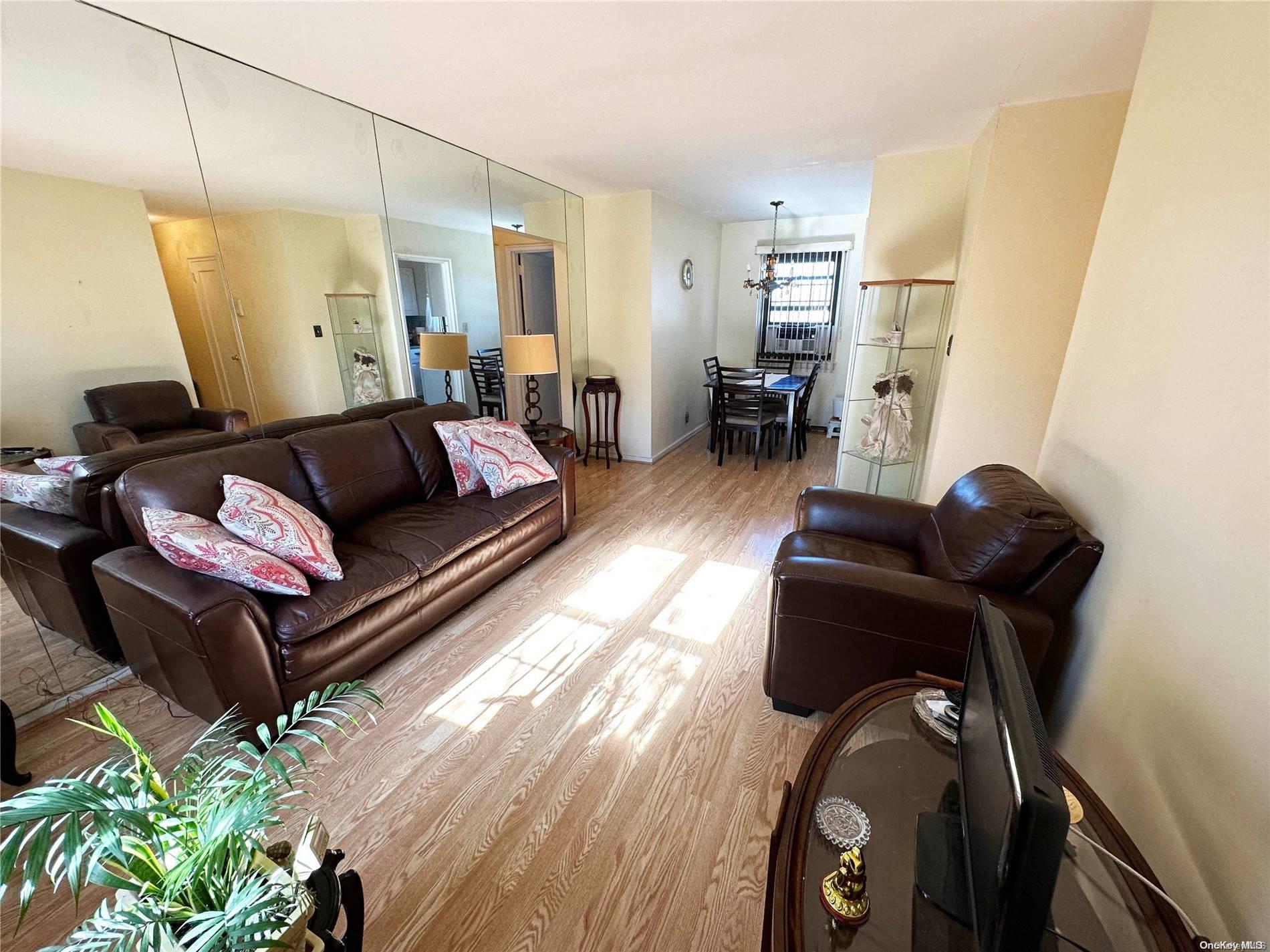 141-30 77th Road, Unit 3A Queens, NY 11367 - Photo 10 of 19 a living room with furniture and a mirror