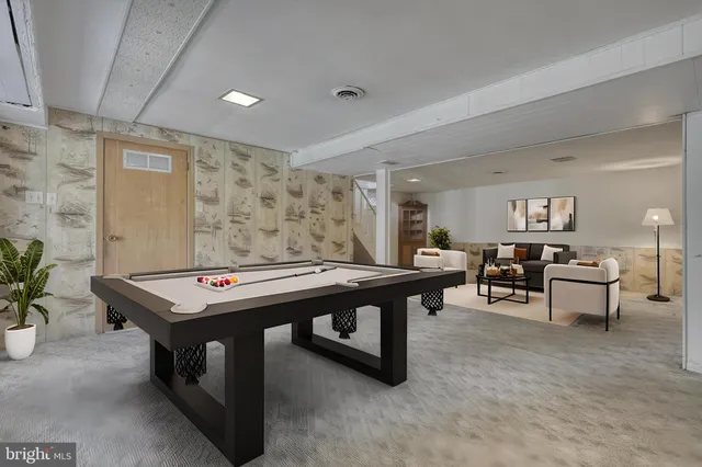 a room with furniture pool table and flat screen tv