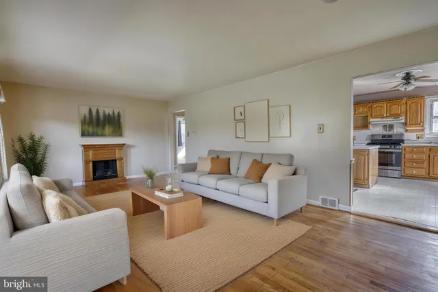 a living room with furniture a fireplace and a table