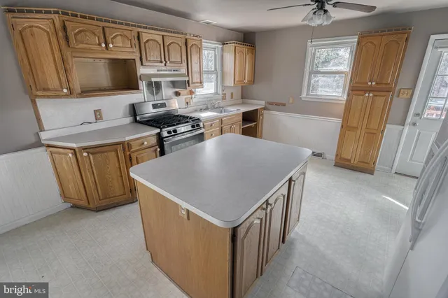 a kitchen with cabinets and refrigerator