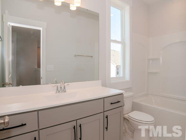 5205 Windmere Chase Drive Raleigh, NC 27616 - Photo 17 of 39 a bathroom with a sink a toilet and a bathtub