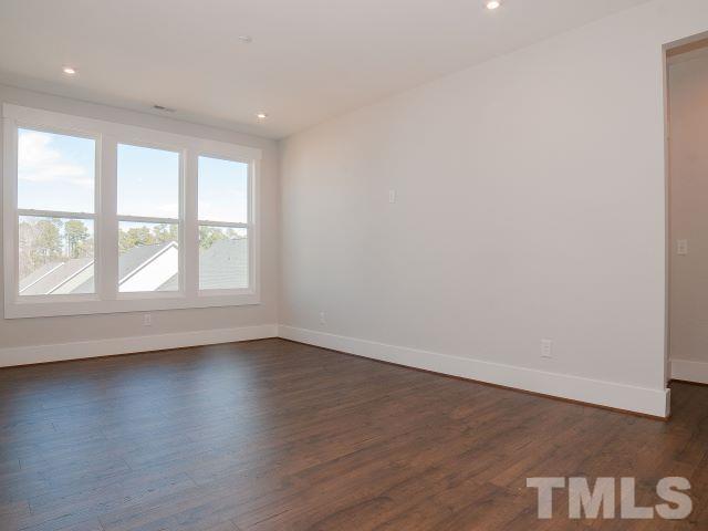 5205 Windmere Chase Drive Raleigh, NC 27616 - Photo 19 of 39 an empty room with wooden floor and windows