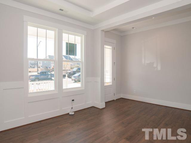 5205 Windmere Chase Drive Raleigh, NC 27616 - Photo 4 of 39 a view of an empty room with wooden floor and a window