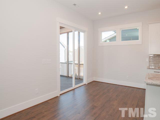 5205 Windmere Chase Drive Raleigh, NC 27616 - Photo 8 of 39 an empty room with wooden floor and windows