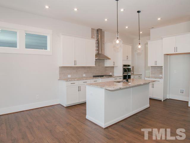 5205 Windmere Chase Drive Raleigh, NC 27616 - Photo 9 of 39 a kitchen with a stove a sink and a refrigerator