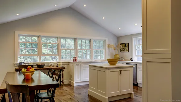 a kitchen with a stove a sink and cabinets