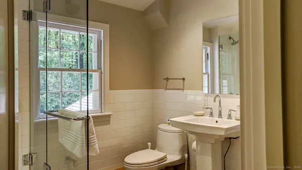a bathroom with a sink toilet and shower