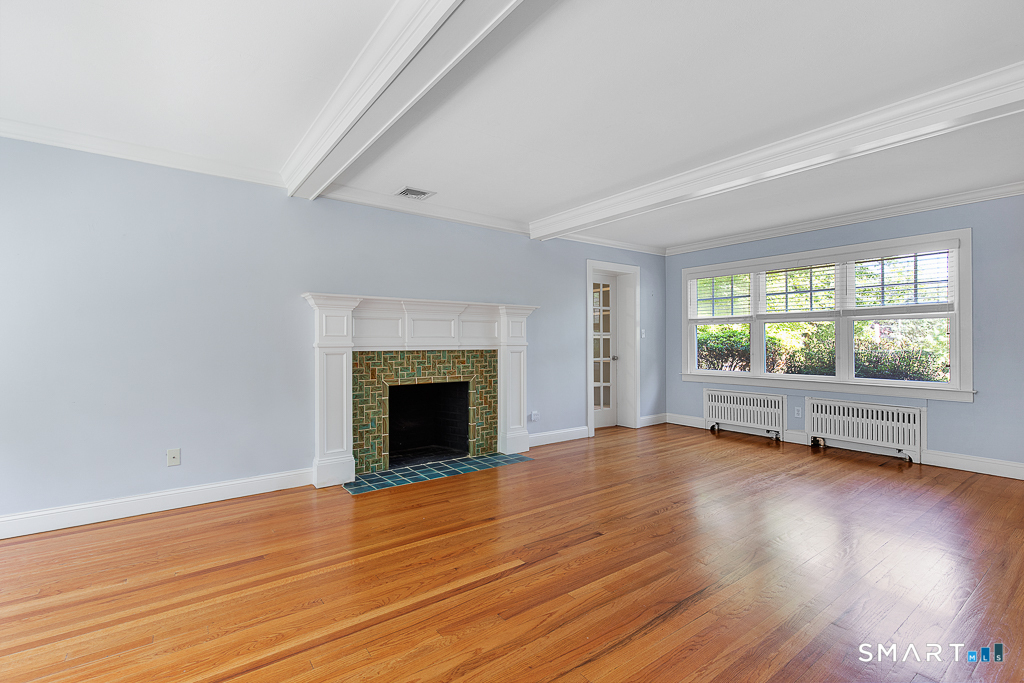 134 Dyer Street New Haven, CT 06511 - Photo 12 of 26 an empty room with wooden floor fireplace and windows