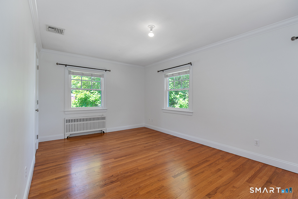 134 Dyer Street New Haven, CT 06511 - Photo 17 of 26 an empty room with wooden floor and windows