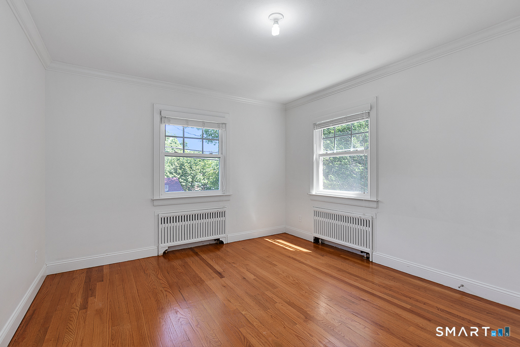 134 Dyer Street New Haven, CT 06511 - Photo 19 of 26 an empty room with wooden floor and windows