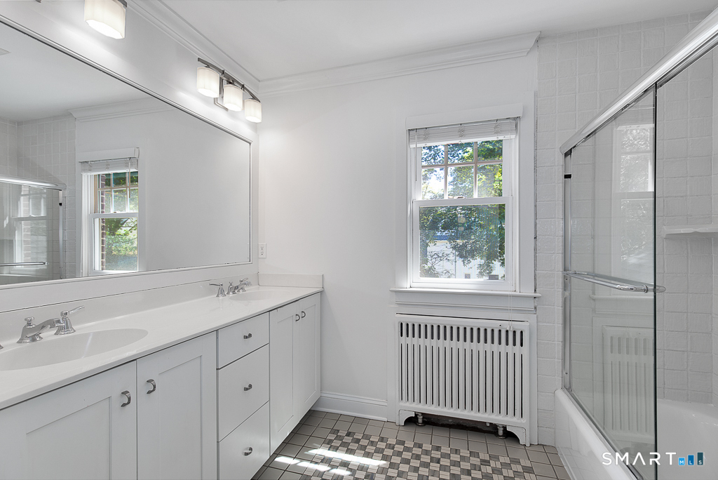 134 Dyer Street New Haven, CT 06511 - Photo 20 of 26 a bathroom with a sink window and a mirror