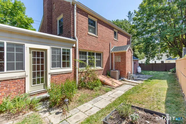 a view of a house with backyard and sitting area