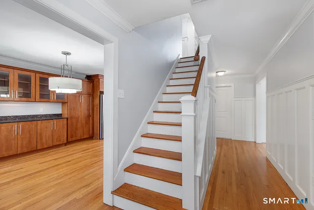 a view of a kitchen with wooden floor and stairs