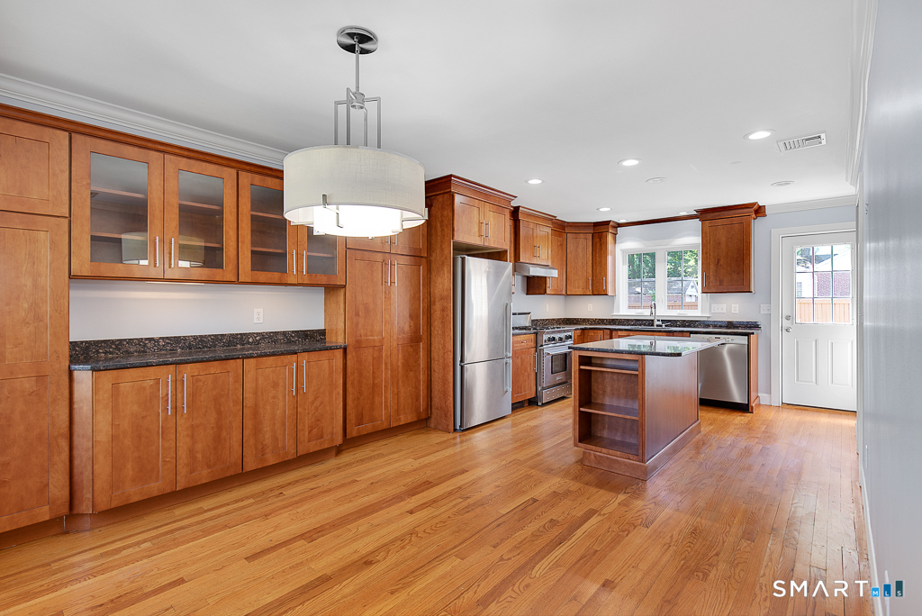 134 Dyer Street New Haven, CT 06511 - Photo 6 of 26 a open kitchen with stainless steel appliances granite countertop a refrigerator a stove and a wooden floors