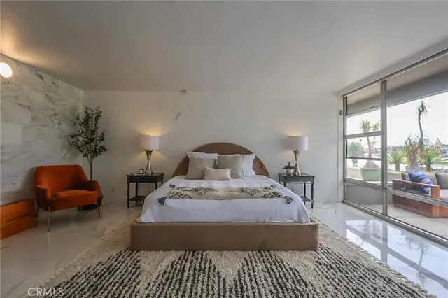a living room with furniture and a floor to ceiling window