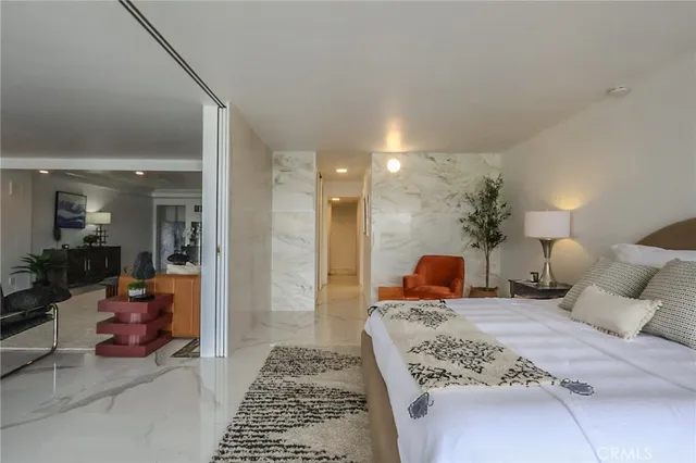 a bathroom with a granite countertop toilet a sink and a mirror