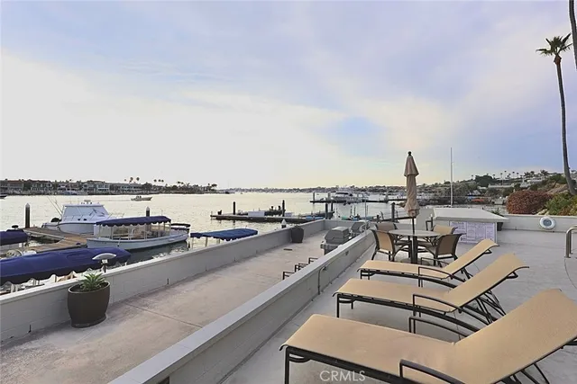 a living room with patio furniture and a floor to ceiling window