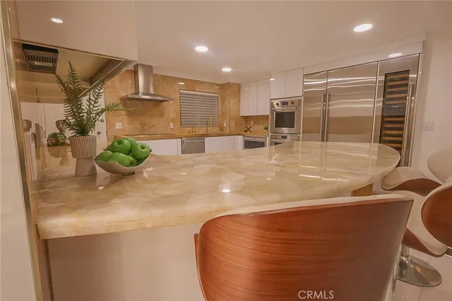 a living room with furniture and a large window with garden view