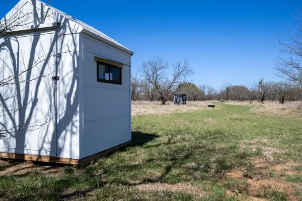 a view of a lake in between two chairs
