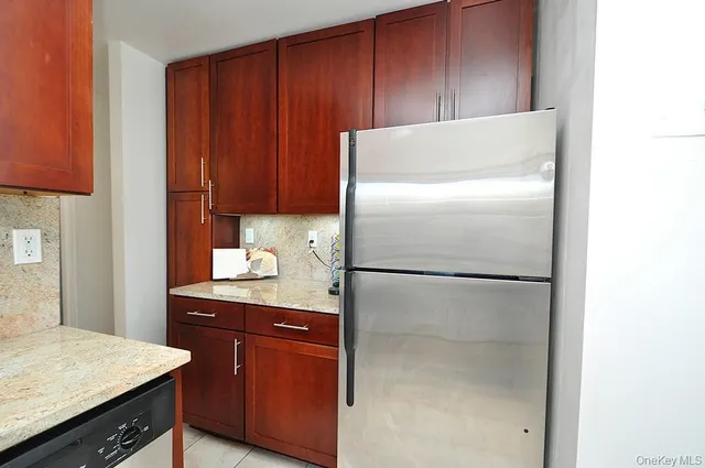 a kitchen with a refrigerator and cabinets