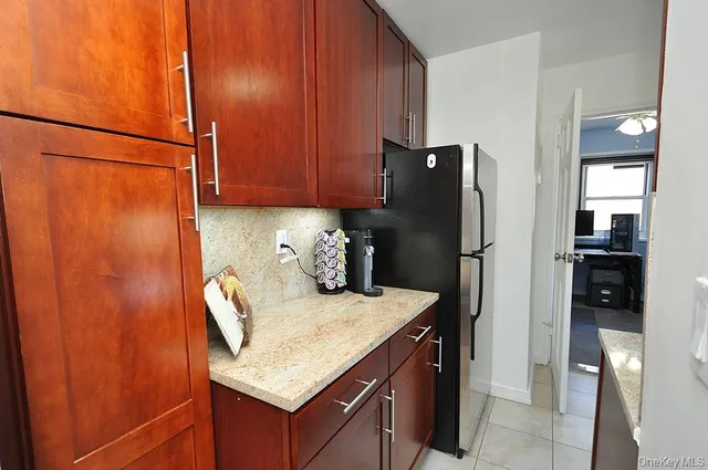 a kitchen with a refrigerator and cabinets