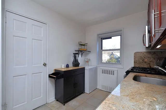 a kitchen with a refrigerator and a stove top oven