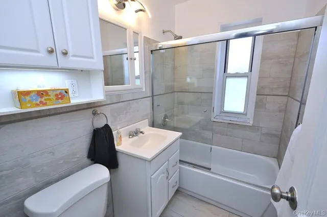 a bathroom with a sink a toilet and bathtub