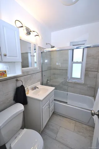 a bathroom with a sink a toilet and bathtub