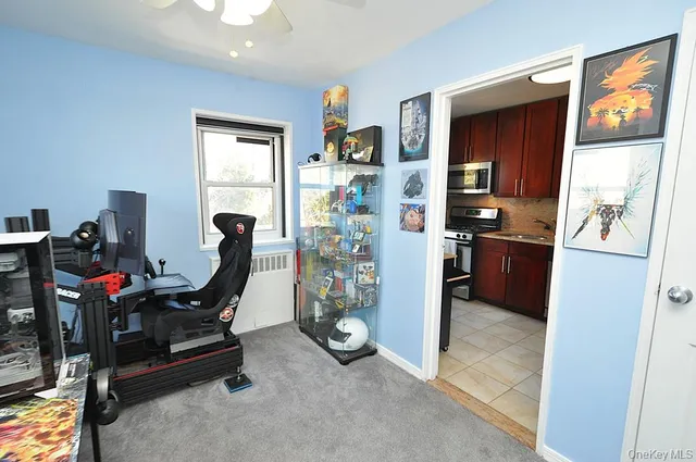 a view of a workspace with furniture and a window