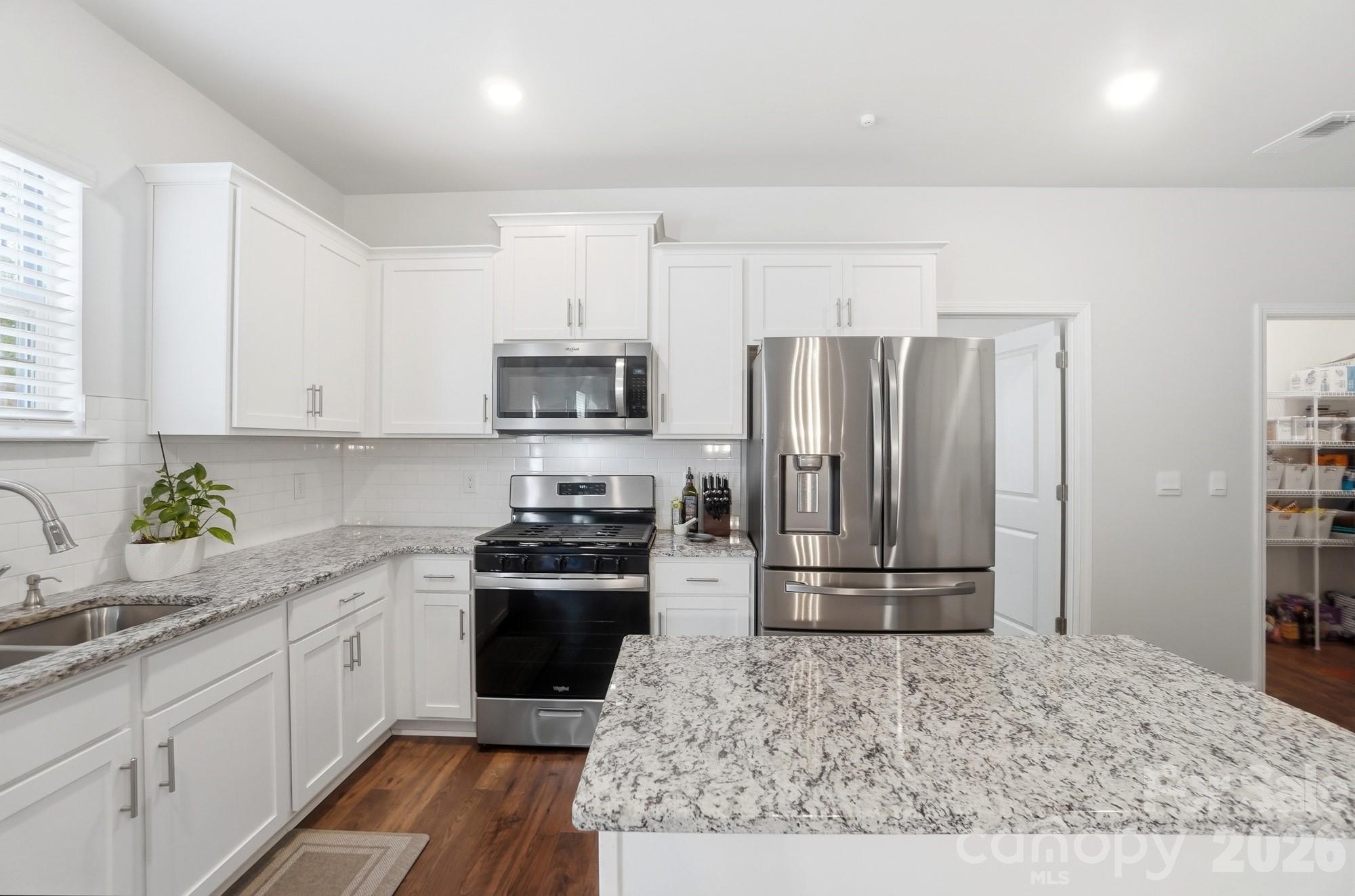 116 Timbergreen Court Troutman, NC 28166 - Photo 13 of 43 a kitchen with a refrigerator sink and stove