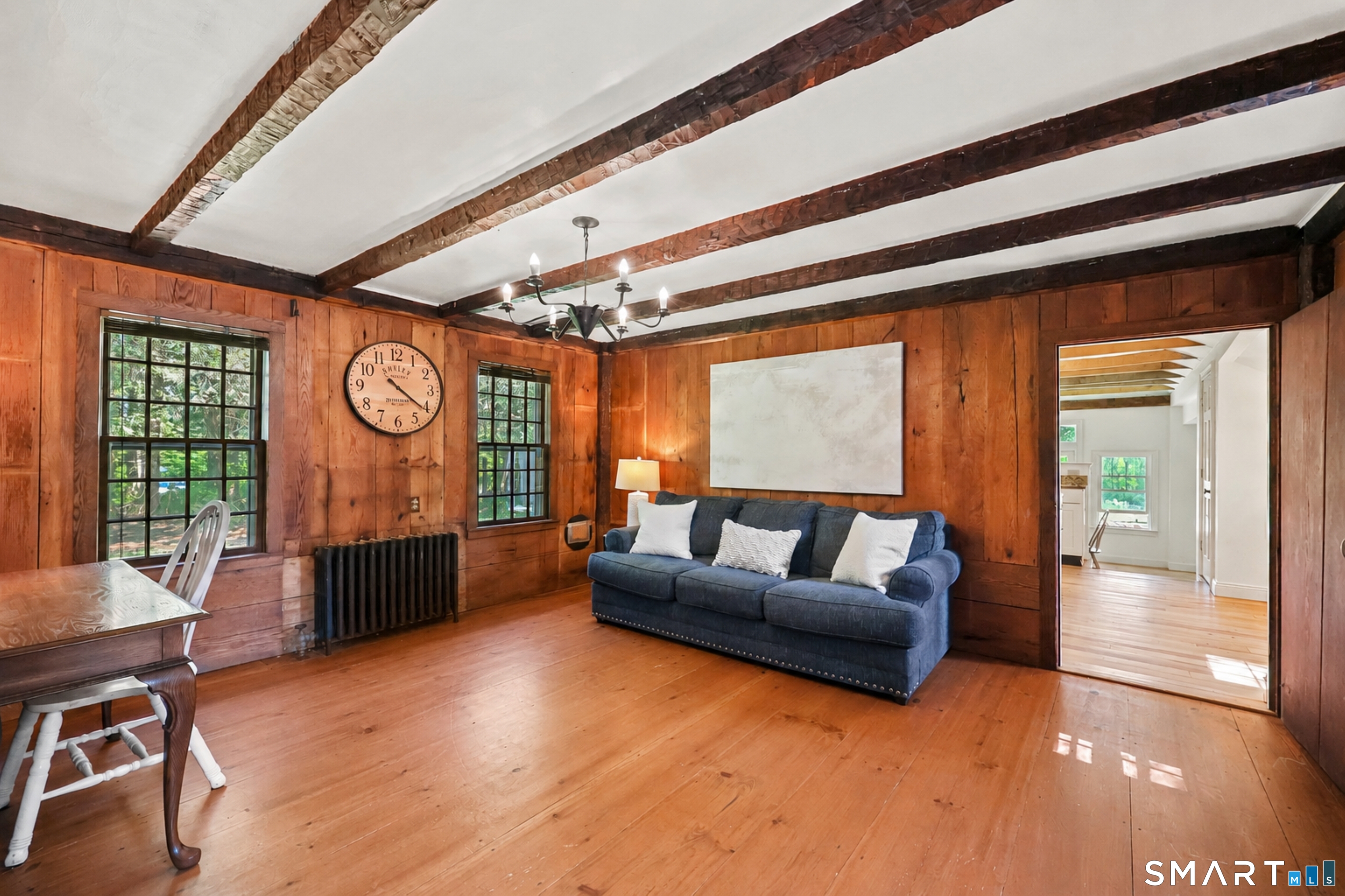 2880 Main Street Coventry, CT 06238 - Photo 11 of 40 Center hall currently serving as a richly detailed office/den with wood-paneled walls & beams.
