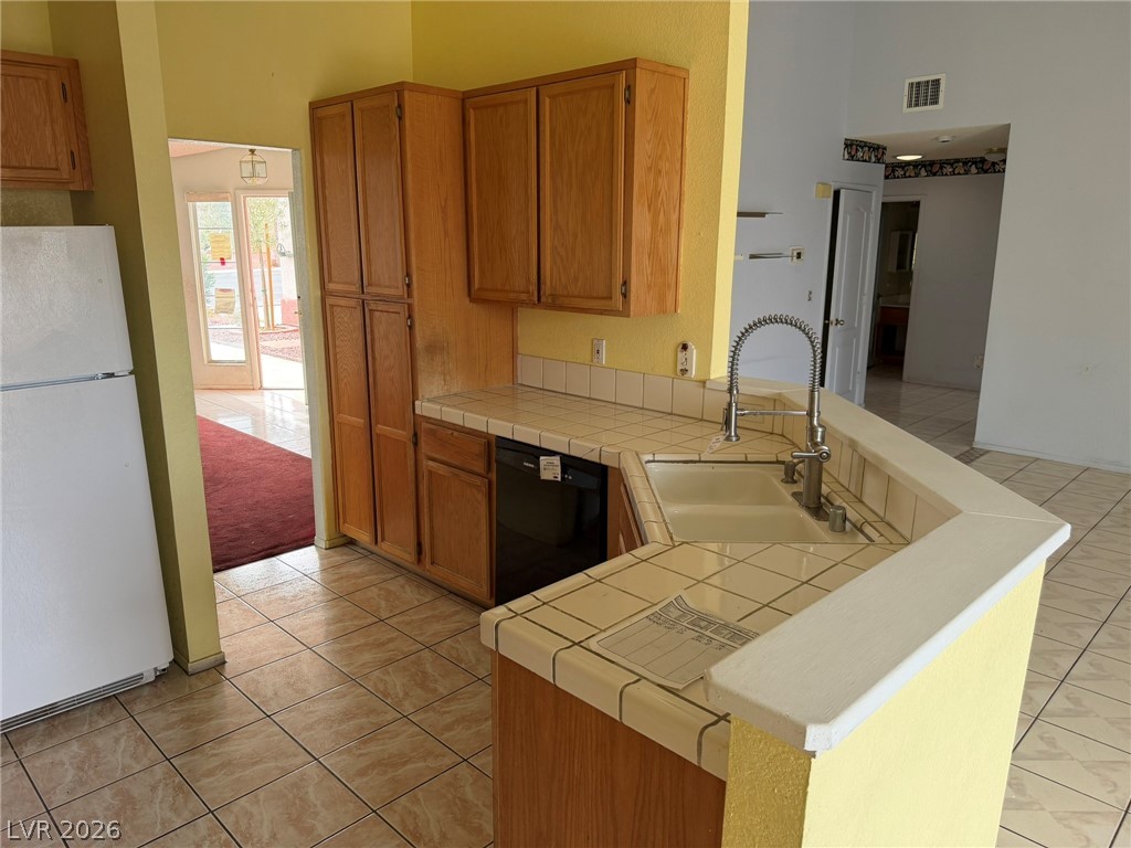 277 Gentle Bay Avenue Henderson, NV 89074 - Photo 21 of 43 This spacious kitchen offers a functional layout with ample cabinet and counter space.
