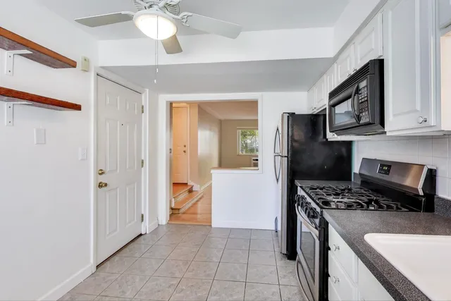a kitchen with stainless steel appliances a refrigerator and a stove top oven
